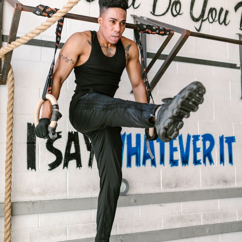 A focused man in athletic gear finding his balance during a workout.