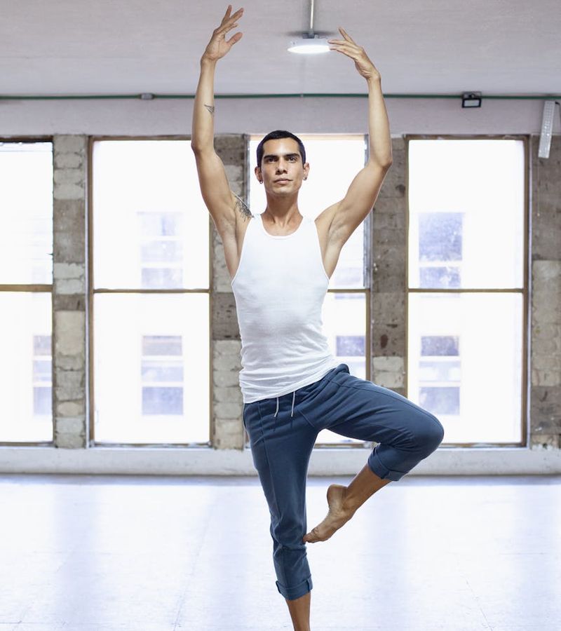 Man performing a controlled strength movement in a calm, focused environment.